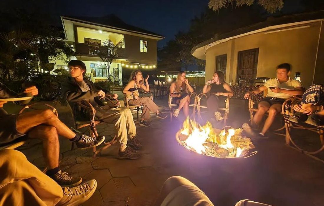 Guest sitting around Bonfire in the hostel in Arusha